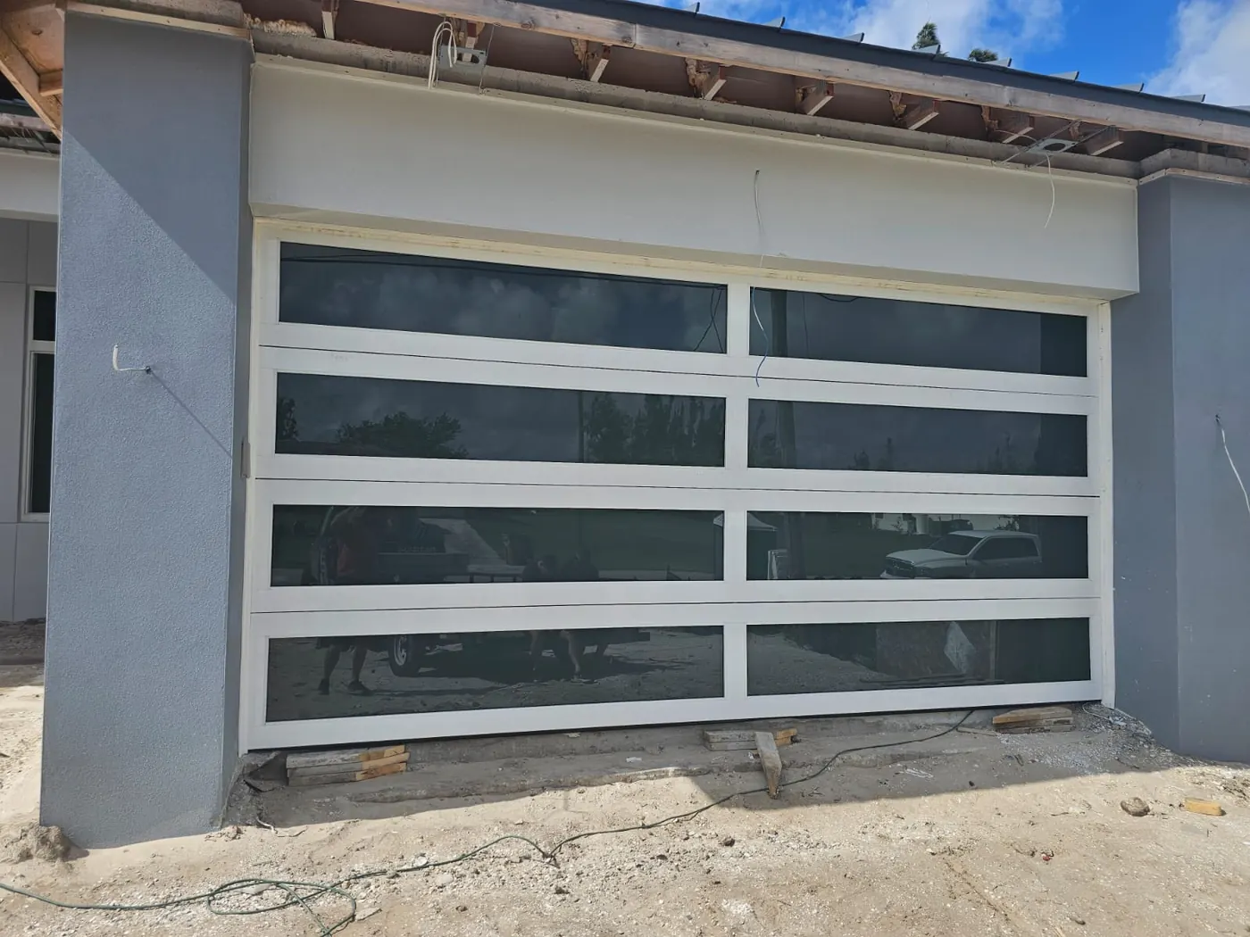 White aluminum frame full-view impact glass garage door, new residential construction