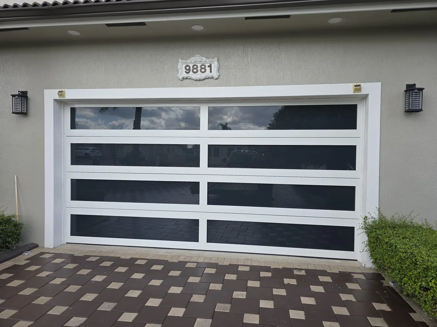 White frame hurricane-rated glass garage door with frosted panels, Miami residence